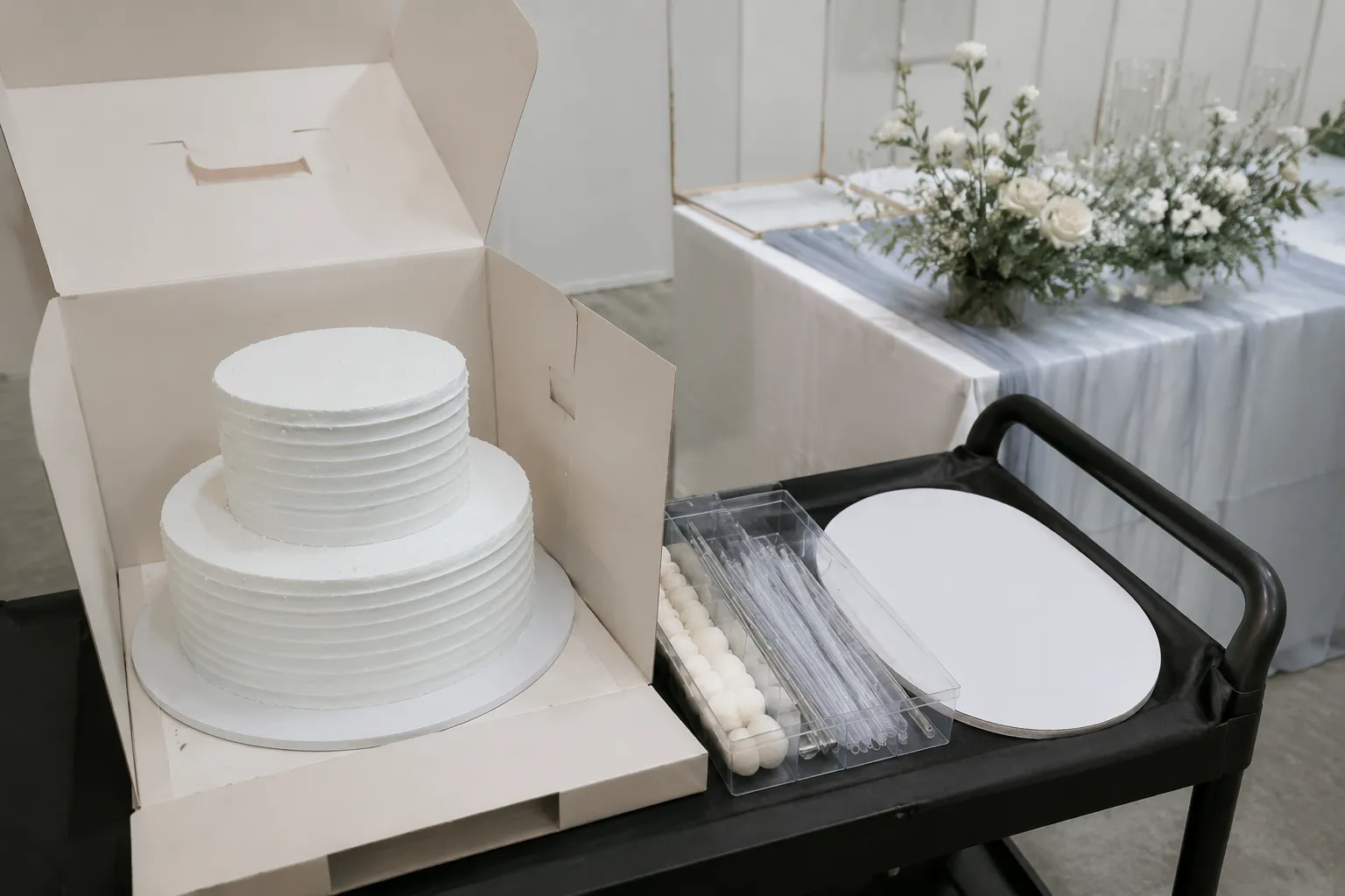 Tiered cake components prepared for delivery, assembly, and venue setup