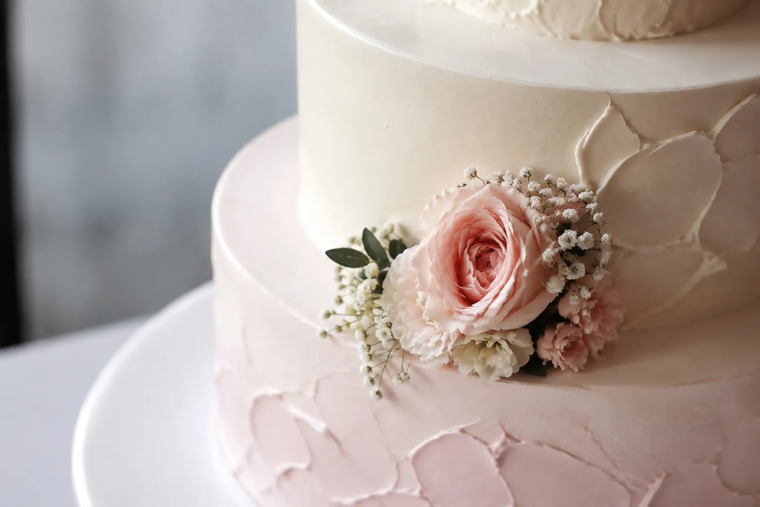 Clustered cake decoration arrangement concentrated beside a tier edge